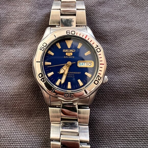 Vintage Seiko Sports 5 Blue Face w/ Gold Accents Silver Band Transparent Back - Picture 1 of 3